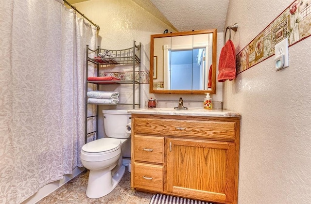 bathroom with a textured ceiling, vanity, toilet, and vaulted ceiling