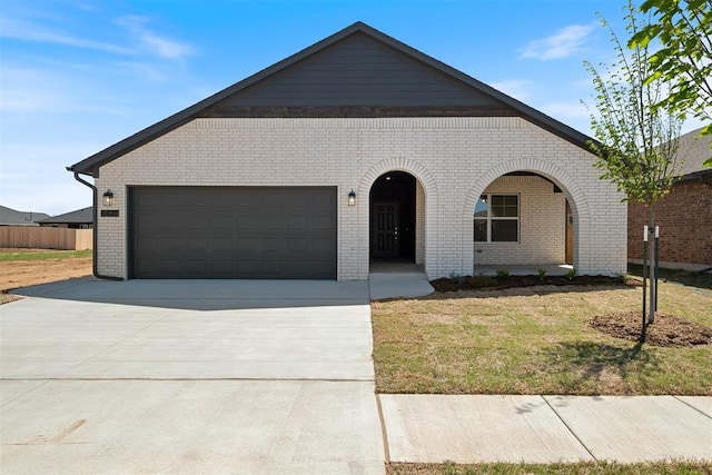 view of front of house with a garage and a front lawn