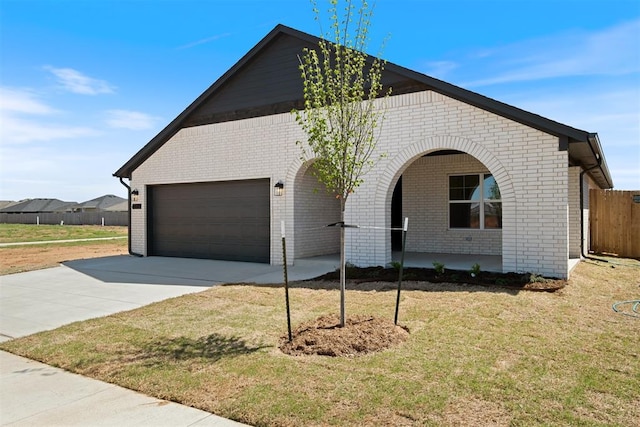 view of front of house with a front yard and a garage