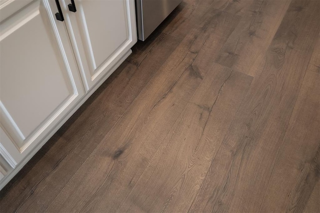 room details featuring white cabinets and dark wood-type flooring