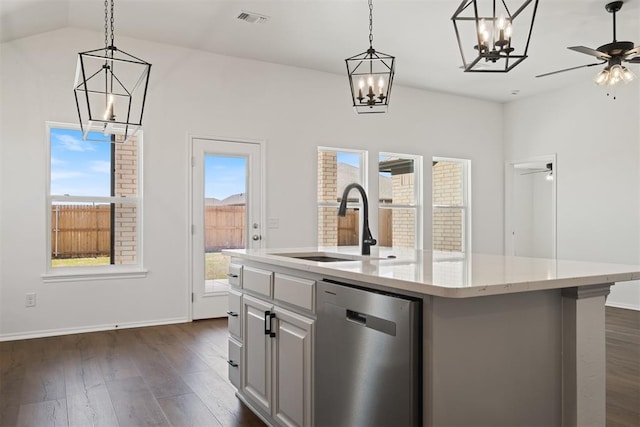 kitchen with a wealth of natural light, a kitchen island with sink, ceiling fan, and stainless steel dishwasher