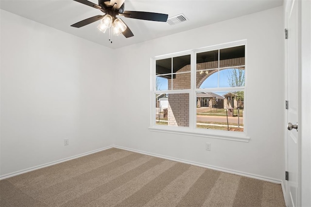 unfurnished room with ceiling fan and carpet floors