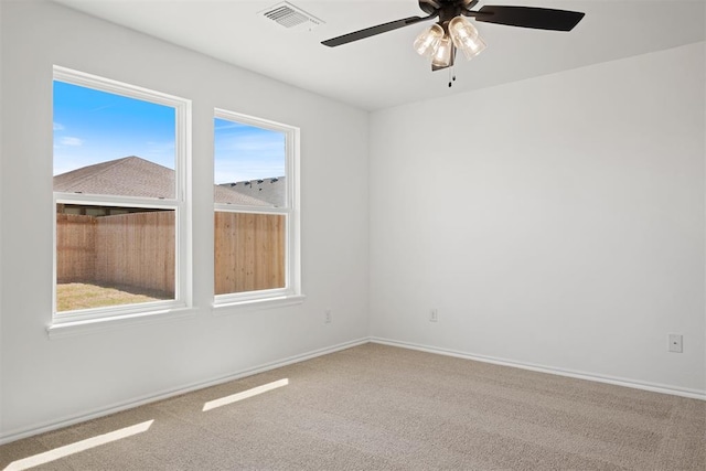 carpeted spare room with ceiling fan