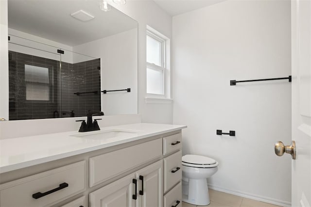 bathroom featuring tile patterned floors, vanity, toilet, and a shower with shower door