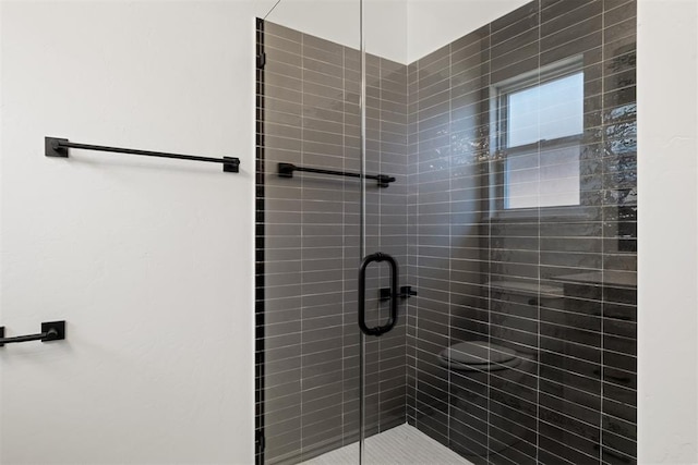 bathroom with a shower with door