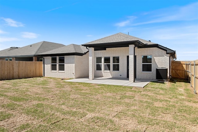 back of property with a patio, a lawn, and central air condition unit