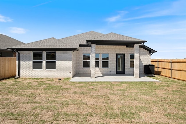 back of property featuring a yard, central AC, and a patio area