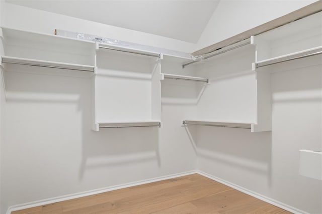 spacious closet featuring hardwood / wood-style flooring and lofted ceiling