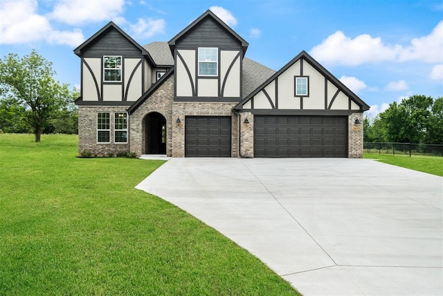 tudor house with a front yard and a garage