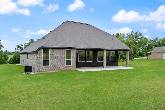 back of property featuring a lawn, central AC, and a patio area