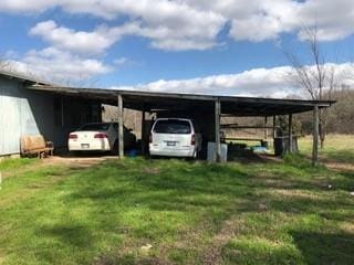 view of parking / parking lot featuring driveway and an attached carport