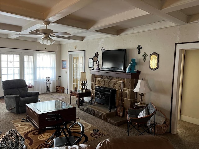 carpeted living room with beam ceiling, a wood stove, ceiling fan, and coffered ceiling