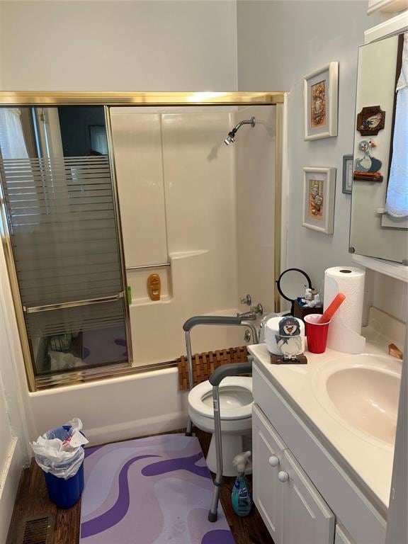 full bathroom with vanity, toilet, and enclosed tub / shower combo