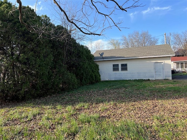 view of side of home with a lawn