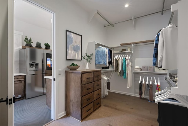 spacious closet with light hardwood / wood-style floors