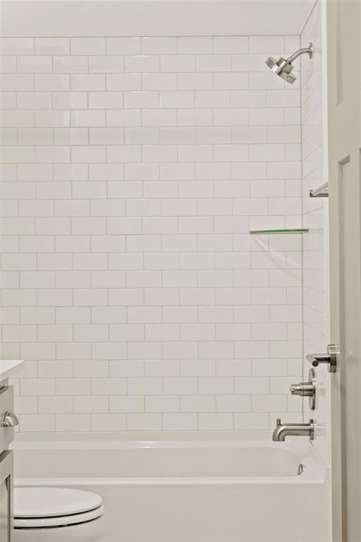 full bathroom featuring vanity, toilet, and tiled shower / bath