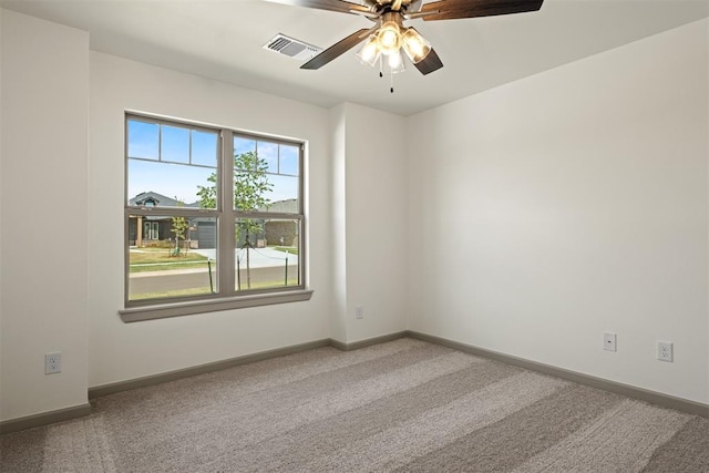 empty room featuring carpet flooring and ceiling fan