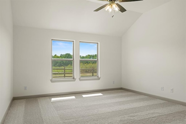 carpeted spare room with vaulted ceiling and ceiling fan