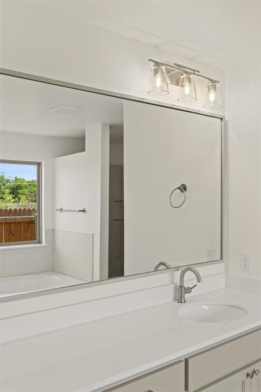 bathroom featuring vanity and a bath