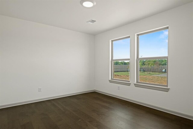 unfurnished room featuring dark wood-type flooring