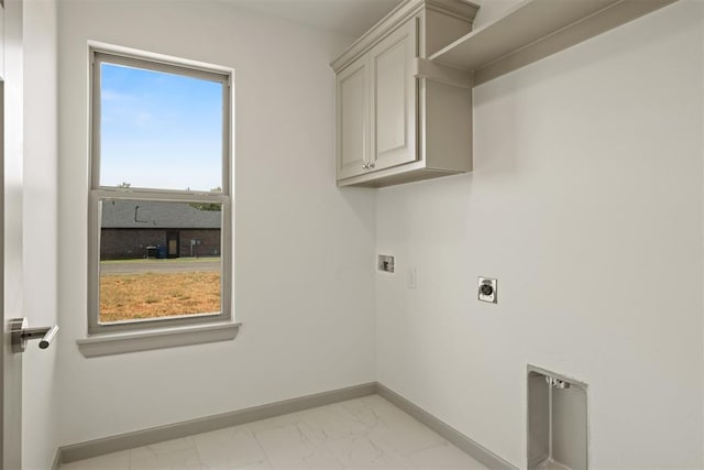 laundry room with washer hookup, electric dryer hookup, and cabinets