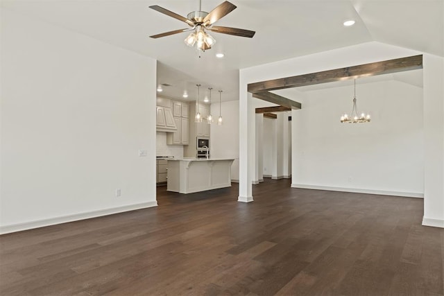 unfurnished living room with ceiling fan with notable chandelier, dark hardwood / wood-style flooring, and vaulted ceiling