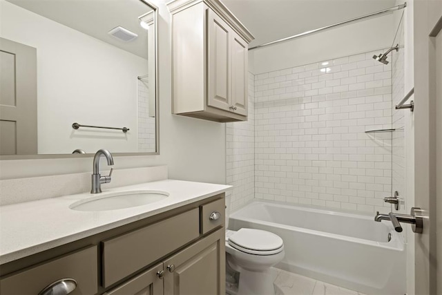 full bathroom with tiled shower / bath, vanity, and toilet