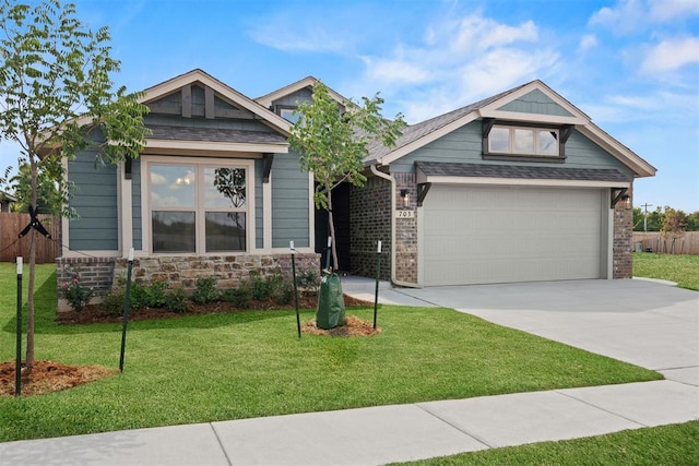 craftsman-style house featuring a front yard and a garage