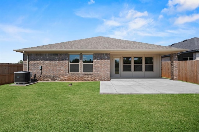 back of house with a yard, a patio, and central air condition unit