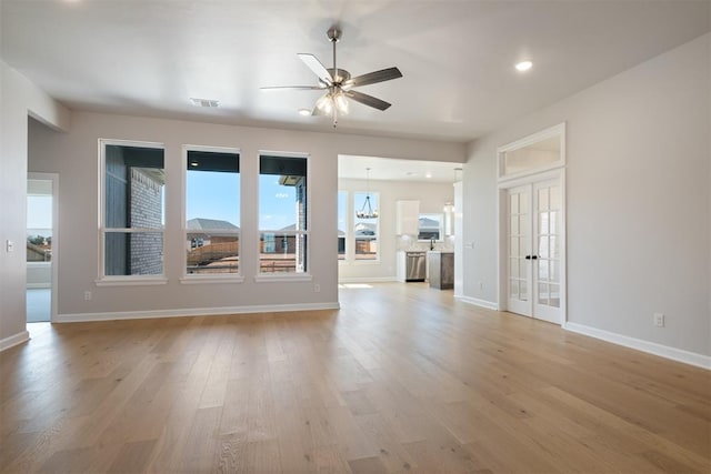 unfurnished living room featuring french doors, light hardwood / wood-style floors, and ceiling fan