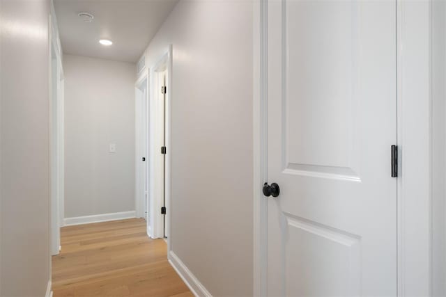 corridor with light hardwood / wood-style flooring