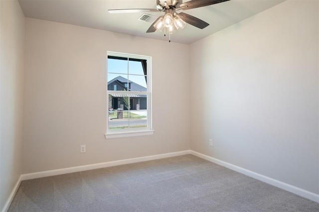 spare room featuring carpet floors and ceiling fan