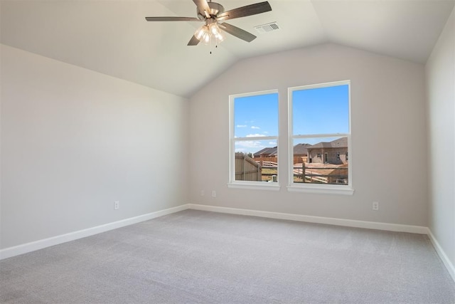 carpeted empty room with ceiling fan and lofted ceiling