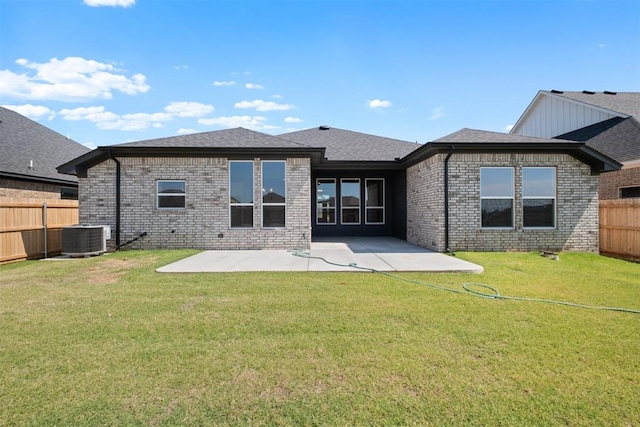 back of property featuring a yard, a patio, and central air condition unit