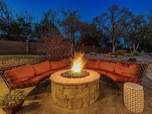 view of patio featuring an outdoor living space with a fire pit