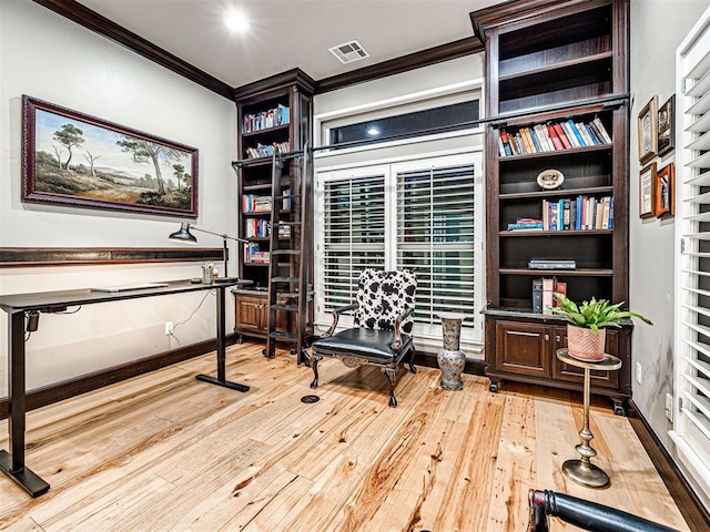 home office with light hardwood / wood-style floors and ornamental molding