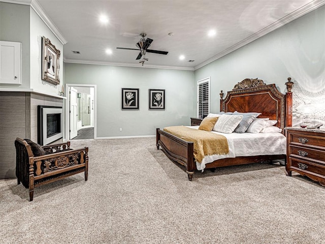 carpeted bedroom with ceiling fan, ornamental molding, and ensuite bath