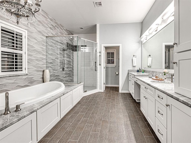 bathroom with separate shower and tub and vanity