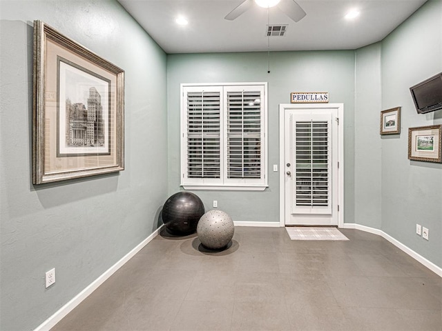 workout room featuring ceiling fan