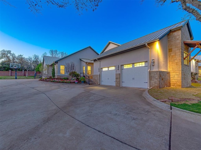 property exterior at dusk featuring a garage