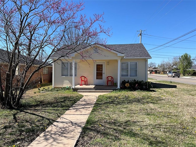 bungalow-style house with covered porch and a front yard