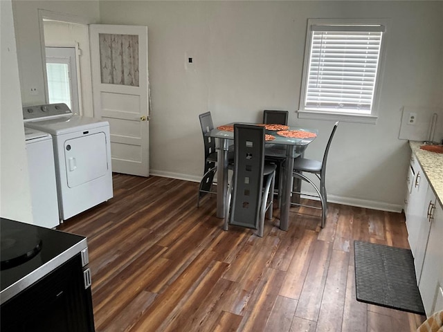 dining area with washer and clothes dryer and dark hardwood / wood-style floors