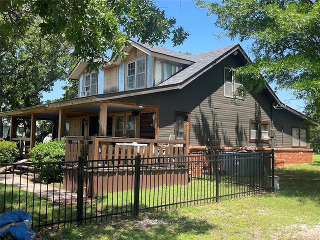 view of front of home with a porch and a front yard