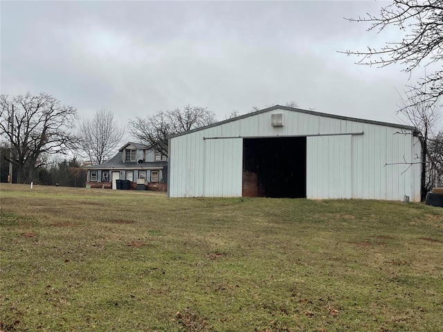 view of outbuilding featuring a lawn