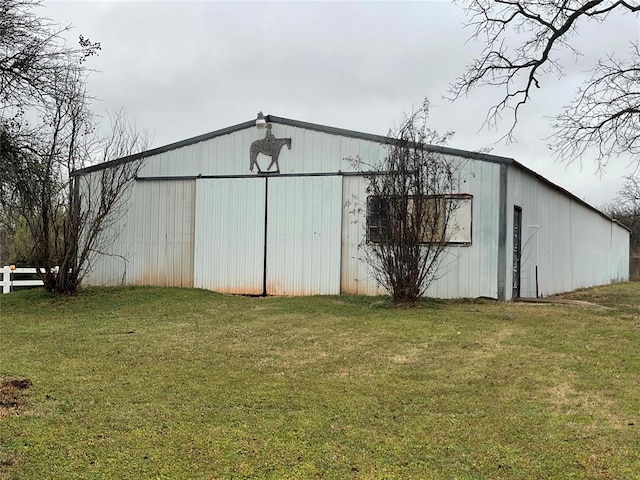 view of outbuilding with a yard