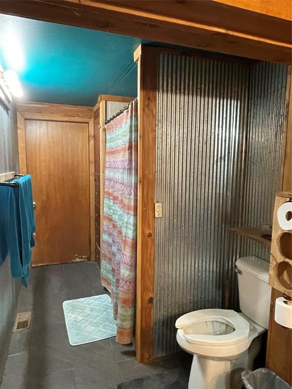 bathroom featuring tile patterned flooring and toilet