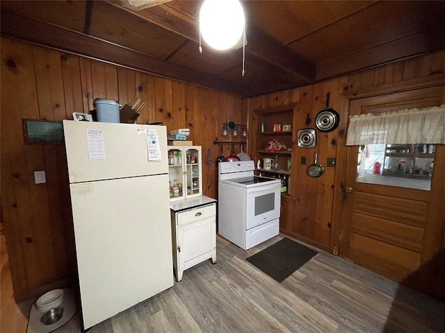 kitchen featuring beam ceiling, wood-type flooring, white appliances, and wooden walls