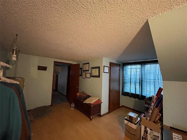 interior space featuring a textured ceiling and light hardwood / wood-style flooring