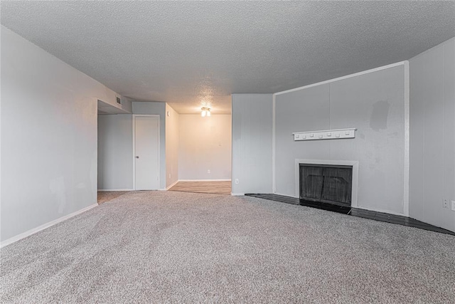 unfurnished living room with carpet and a textured ceiling