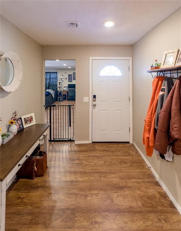 entryway with wood-type flooring